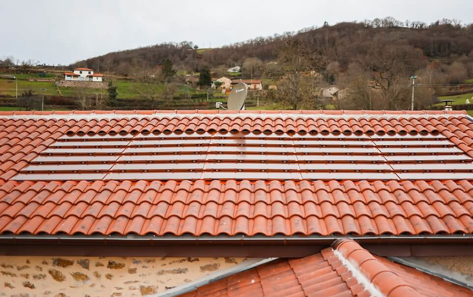 Tuiles solaires couleur terre cuite intégrées à une toiture traditionnelle